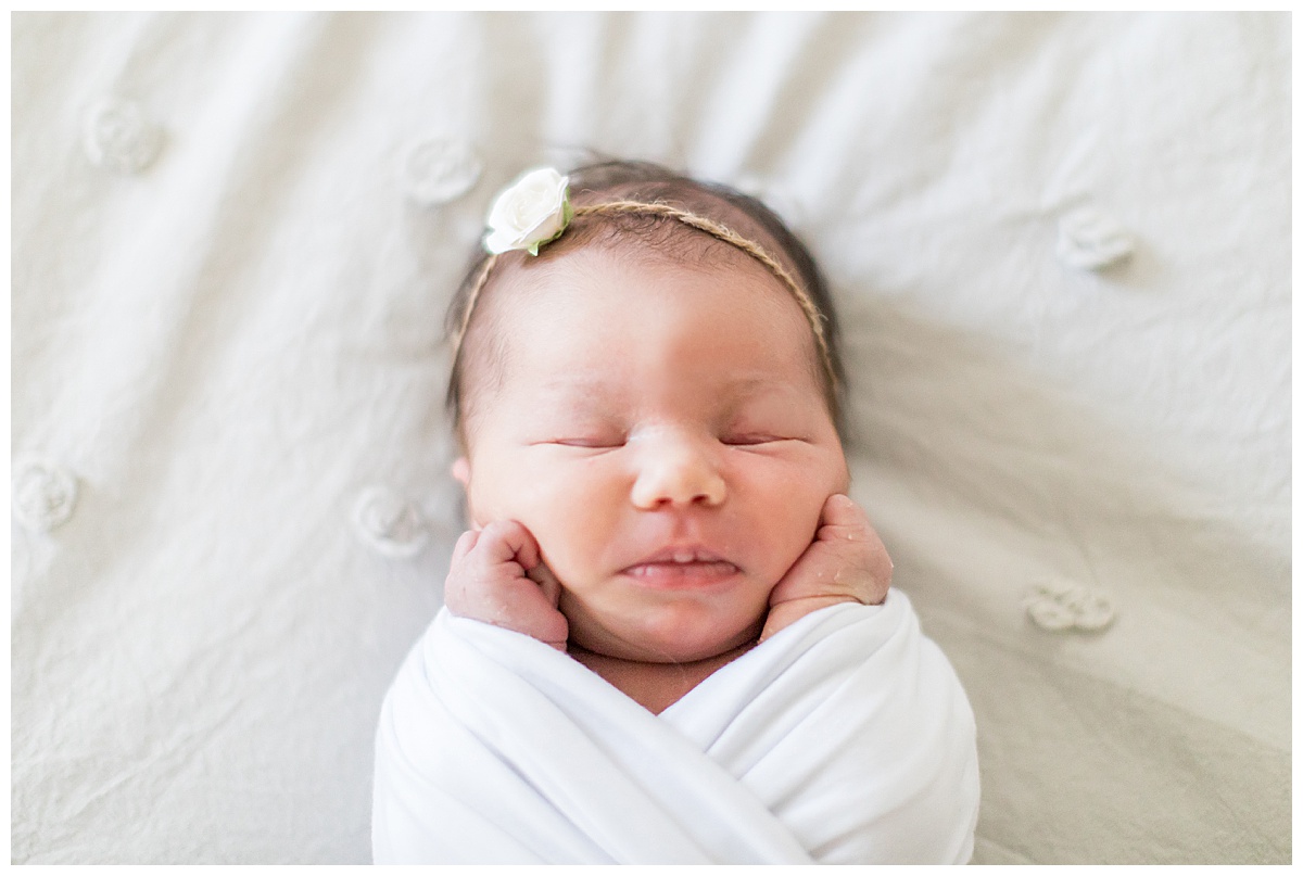 baby girl with white wrap and flower headband