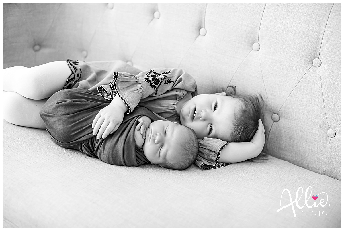 big sister and brother studio newborn photos black and white