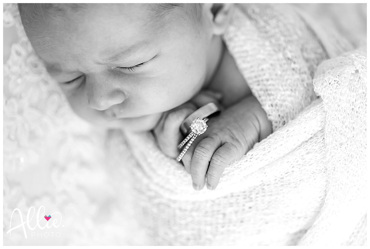 newborn photos at home with wedding dress and rings