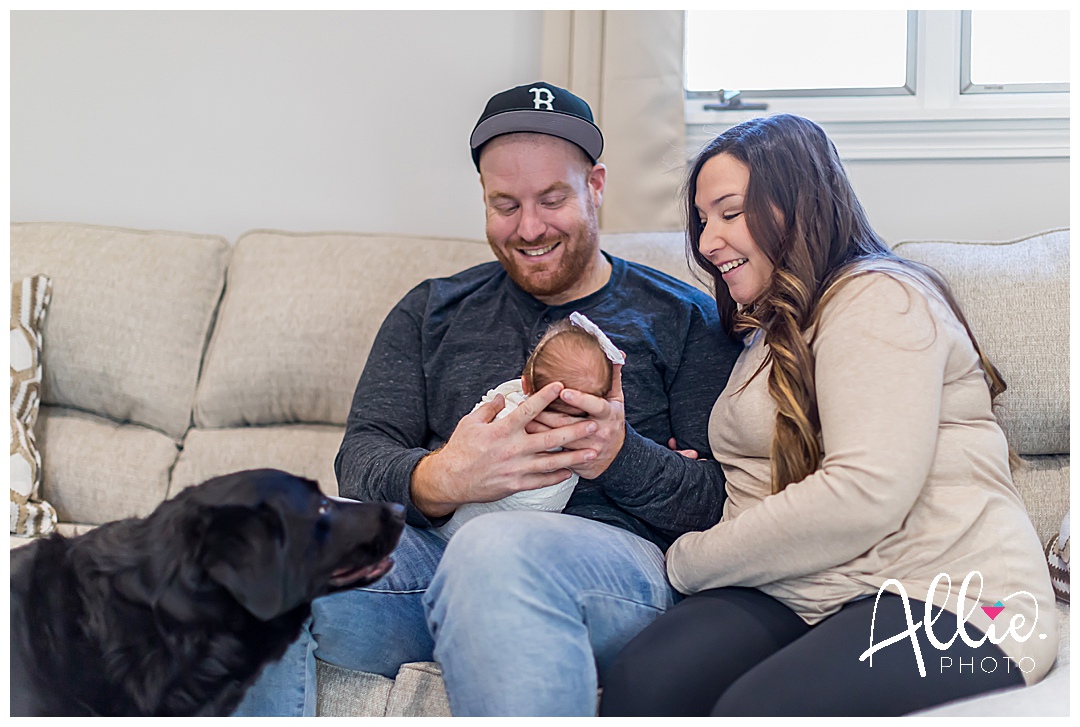baby girl in home newborn photos with dog