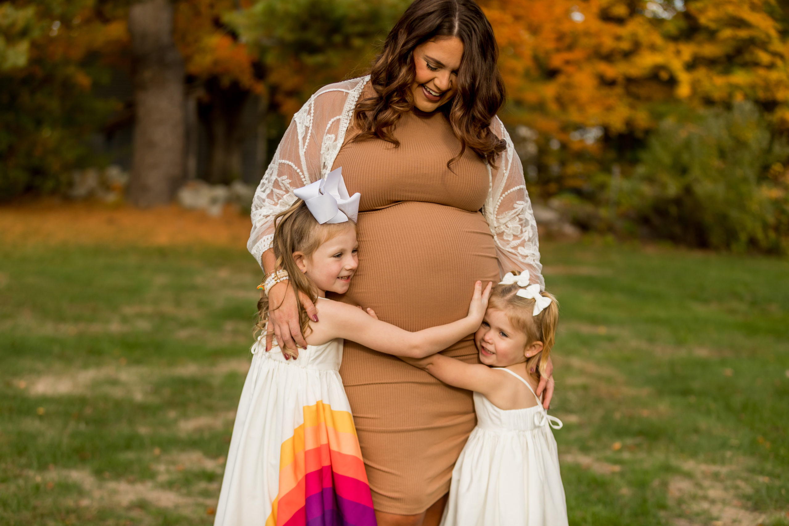rainbow baby maternity photos with big sisters hugging mommy's belly chelmsford ma photographer